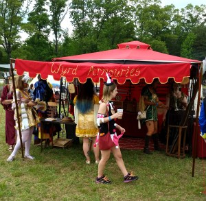 I spent the day before opening finishing the sides and getting sunburn while painting our sign and front trim, while Nathaniel made new stands and tables. 